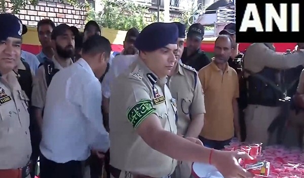 Srinagar: Senior police officials distribute water among Shia mourners participating in Muharram procession